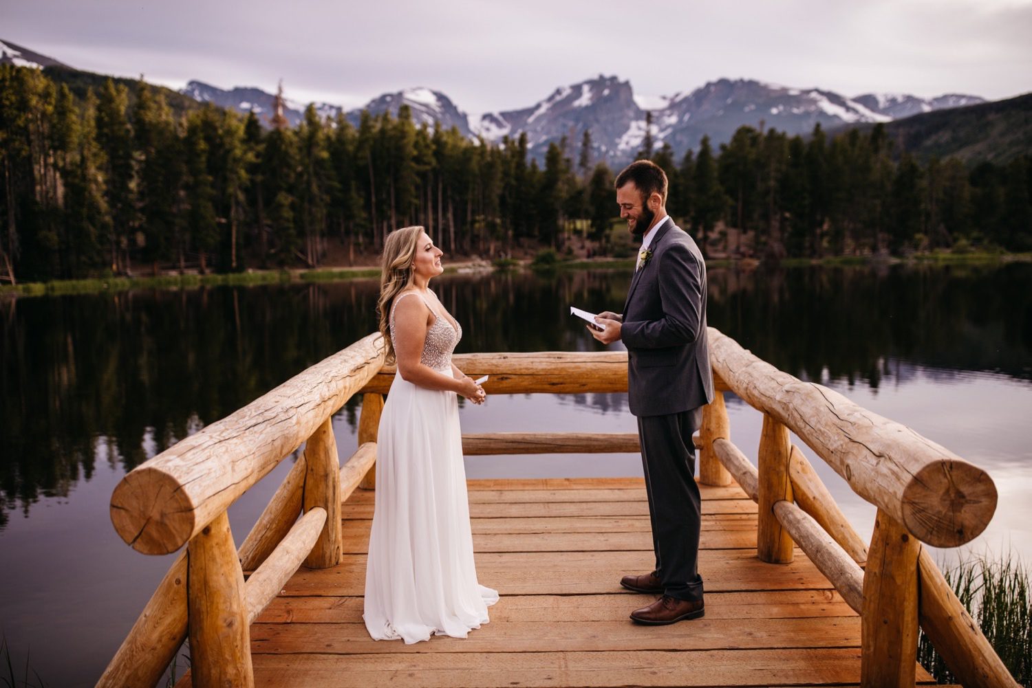 Bride and Groom exchanging vows on the dock at Sprague Lake in Rocky Mountain National Park