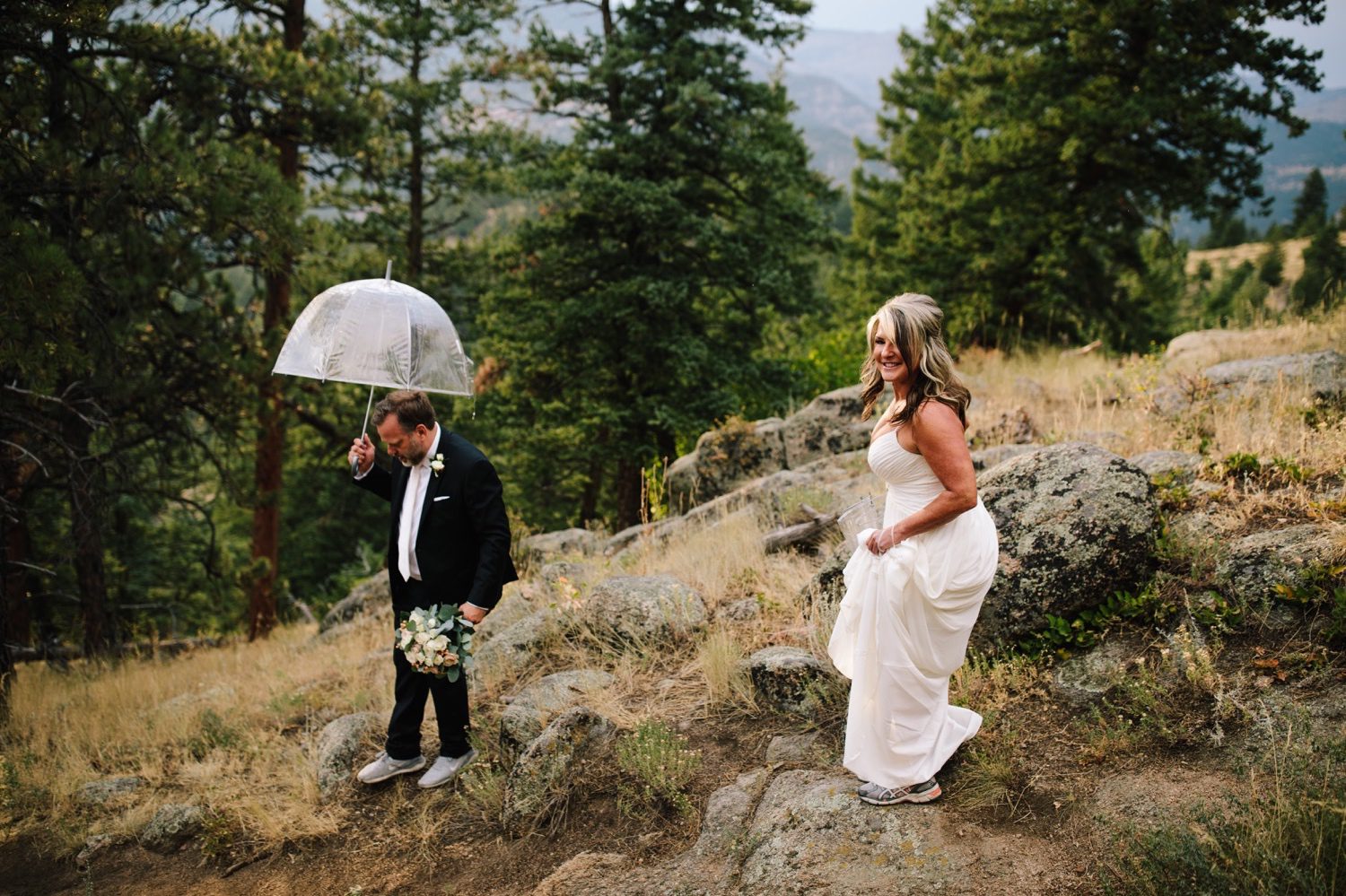 Bride and groom hiking to elopement location
