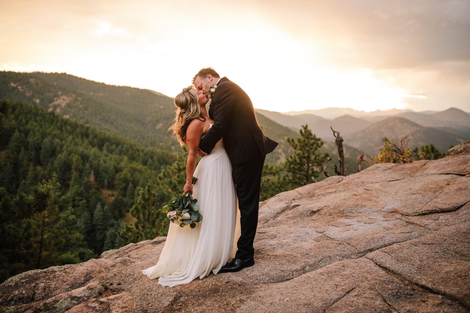 Bride and groom kissing after Colorado mountain elopement