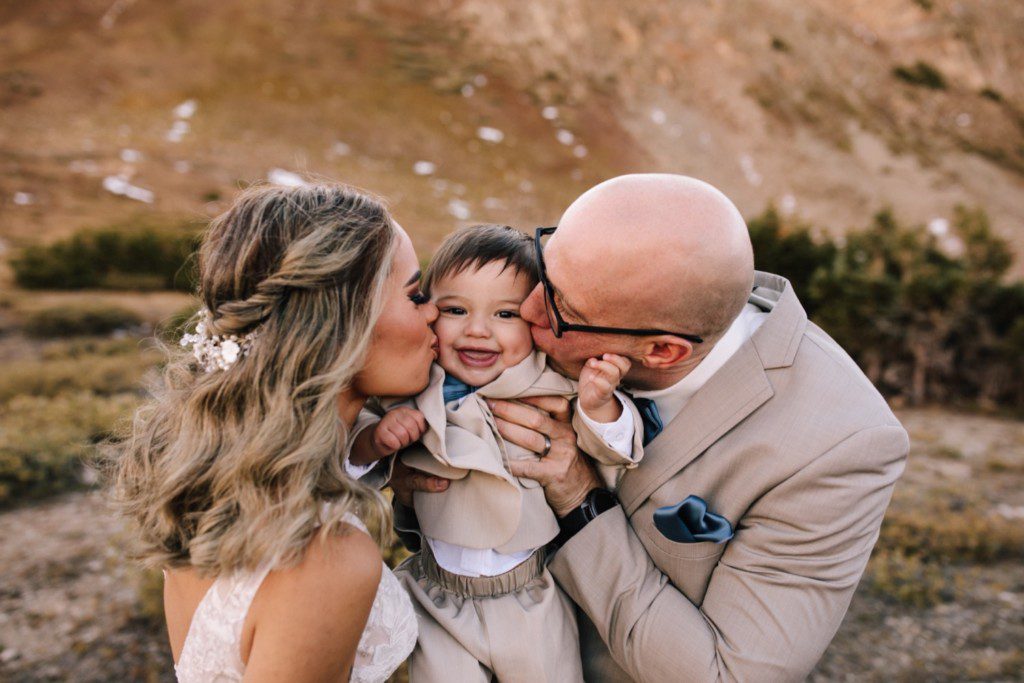 Bride and groom with son on Loveland Pass