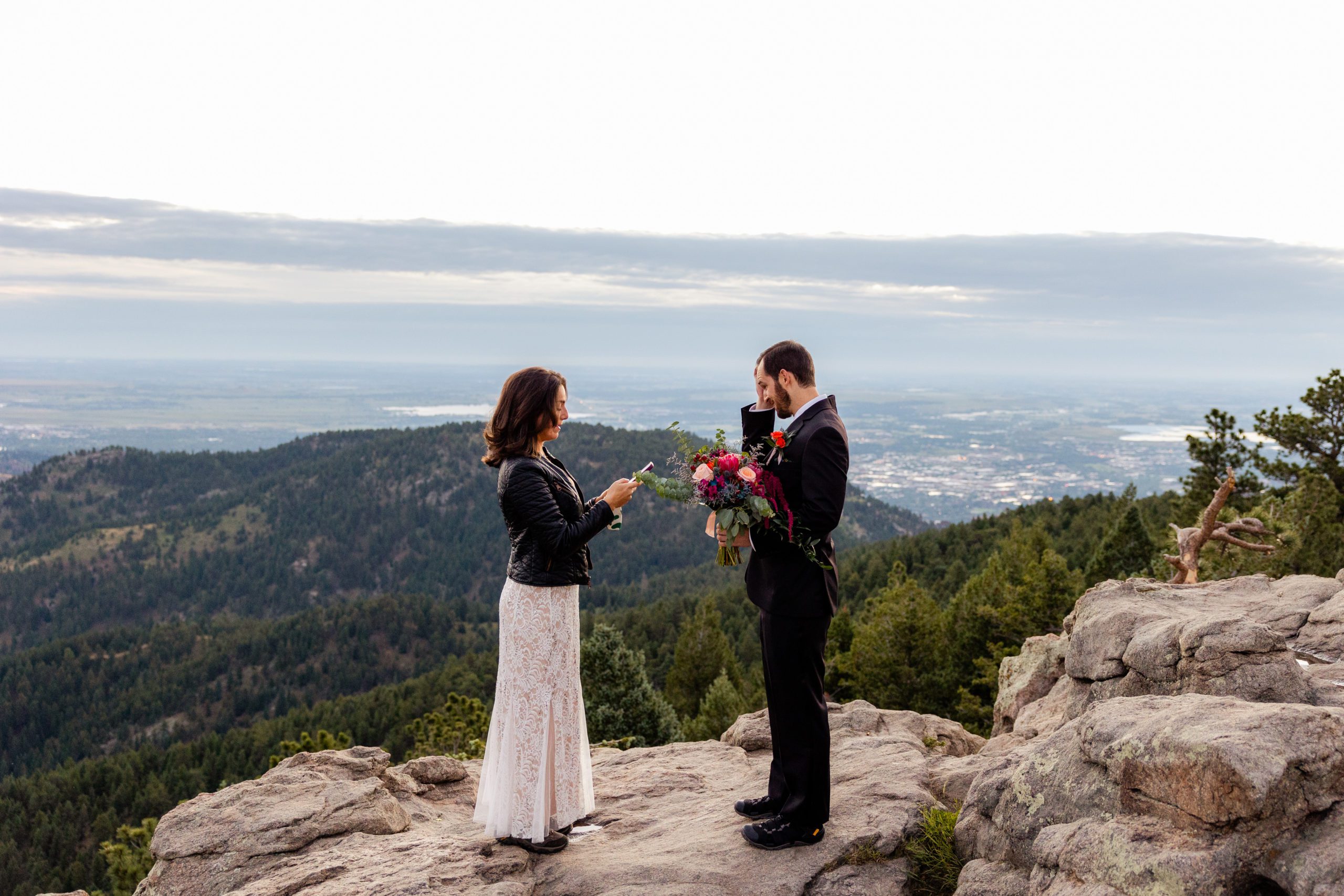 Bride and groom exchange vows during sunrise elopement ceremony at Lost Gulch Overlook in Boulder