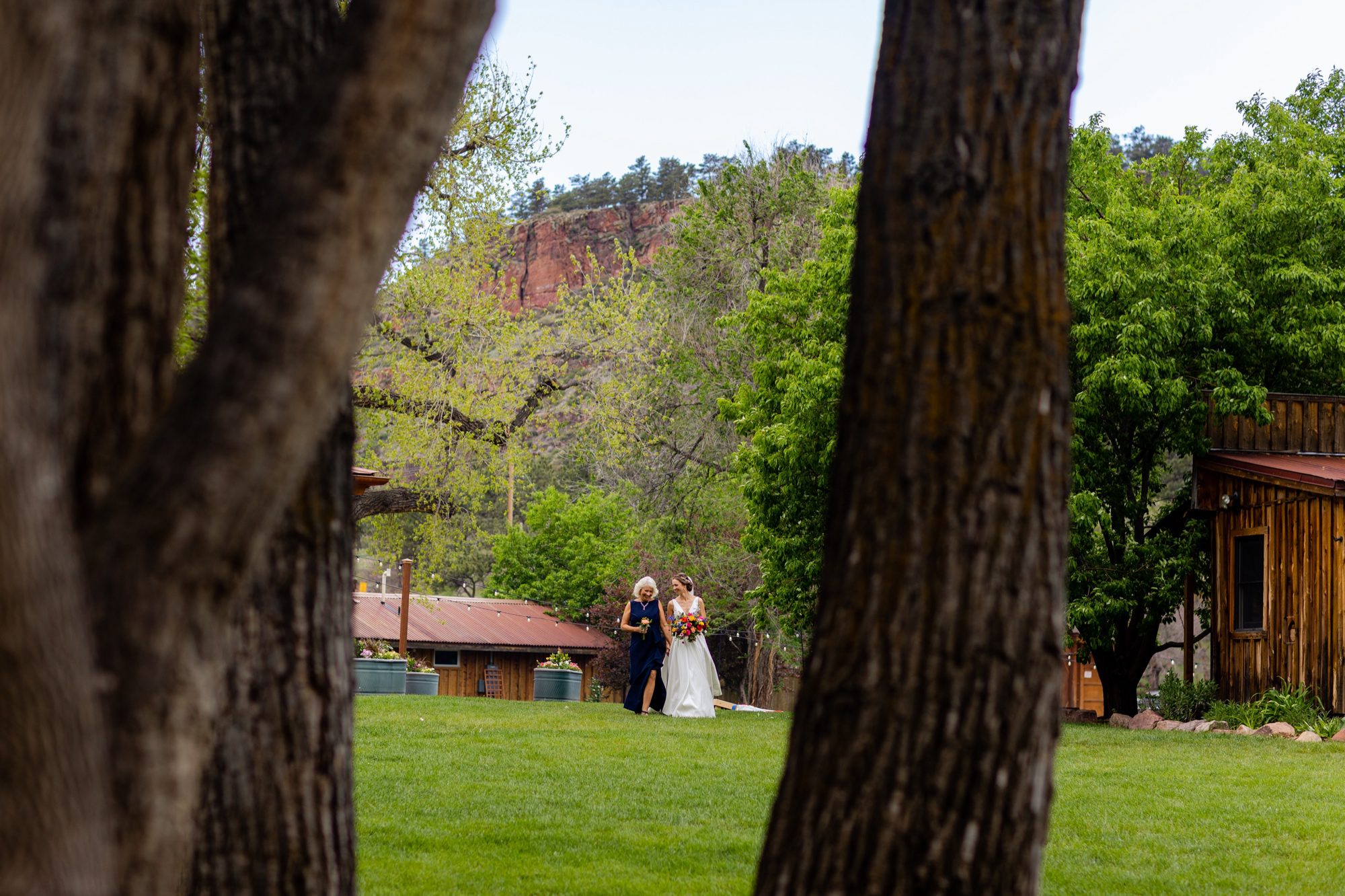 Bride and mom walking down the aisle, Planet Bluegrass Wedding venue in Lyons Colorado: Colorado Wedding Photographer, Wedding ceremony