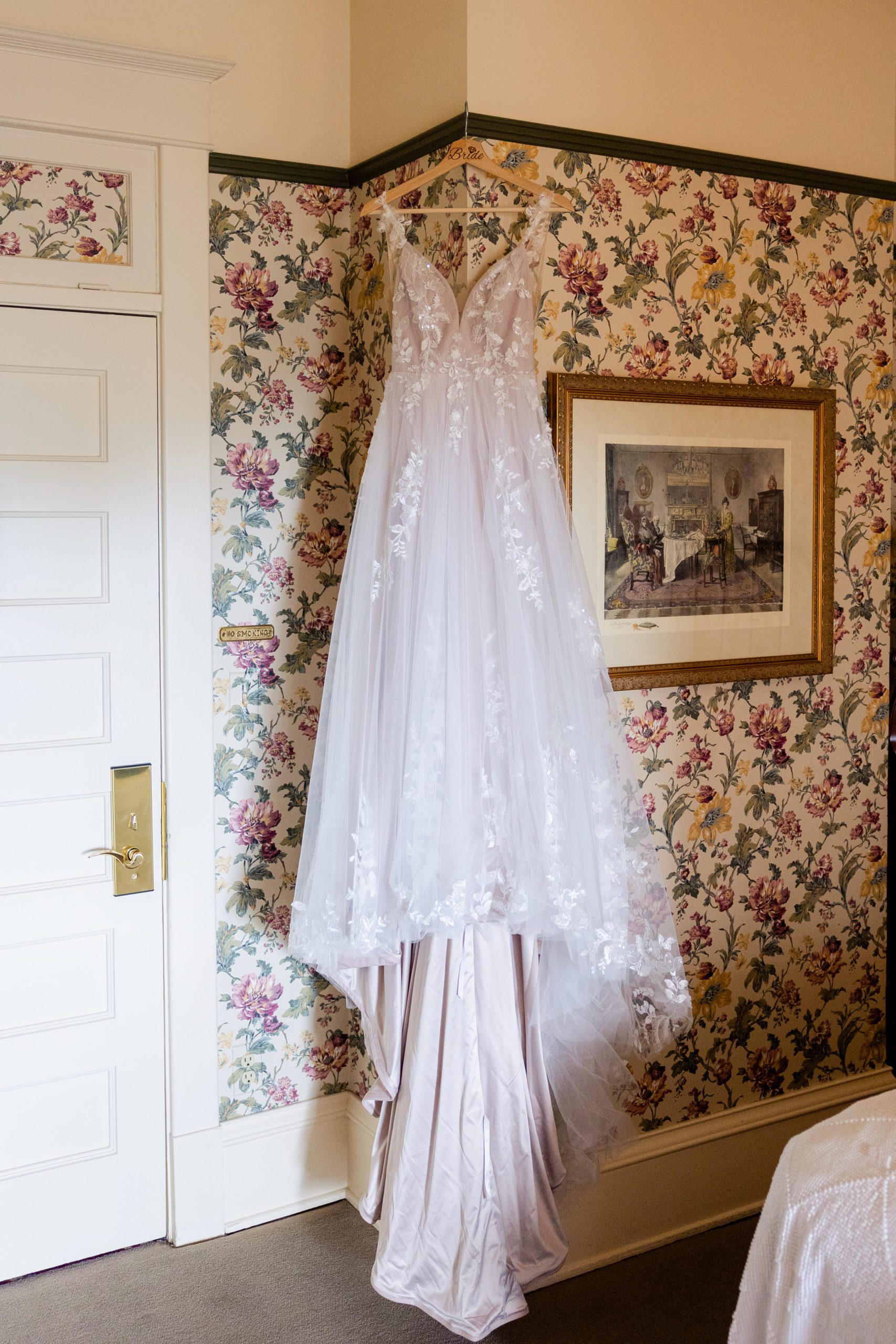 Wedding dress from LUV Bridal hanging up in the bridal suite in Hotel Boulderado
