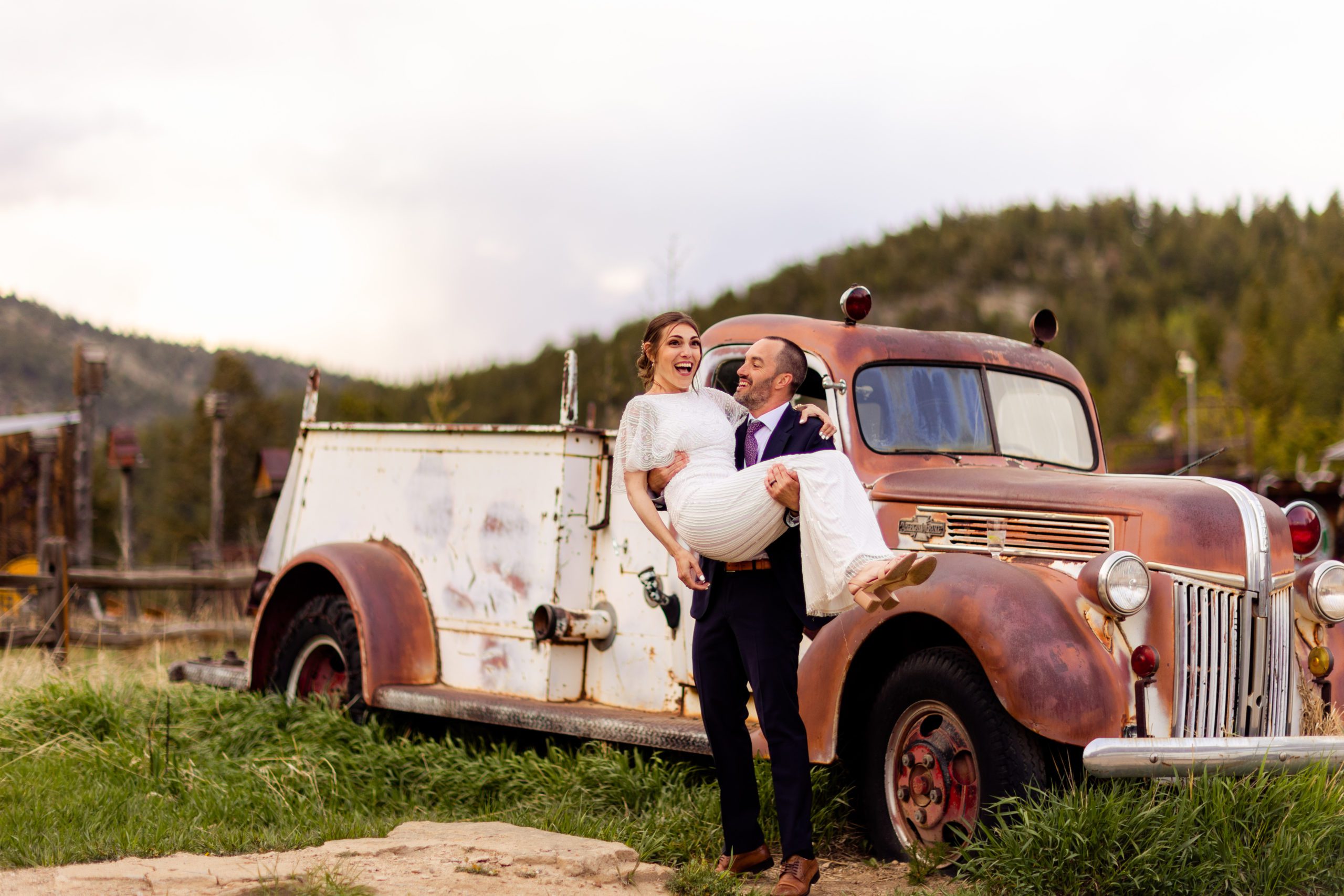 Sunset bride and groom portraits, wedding photos with vintage truck at Gold Hill Inn, BHLDN wedding dress