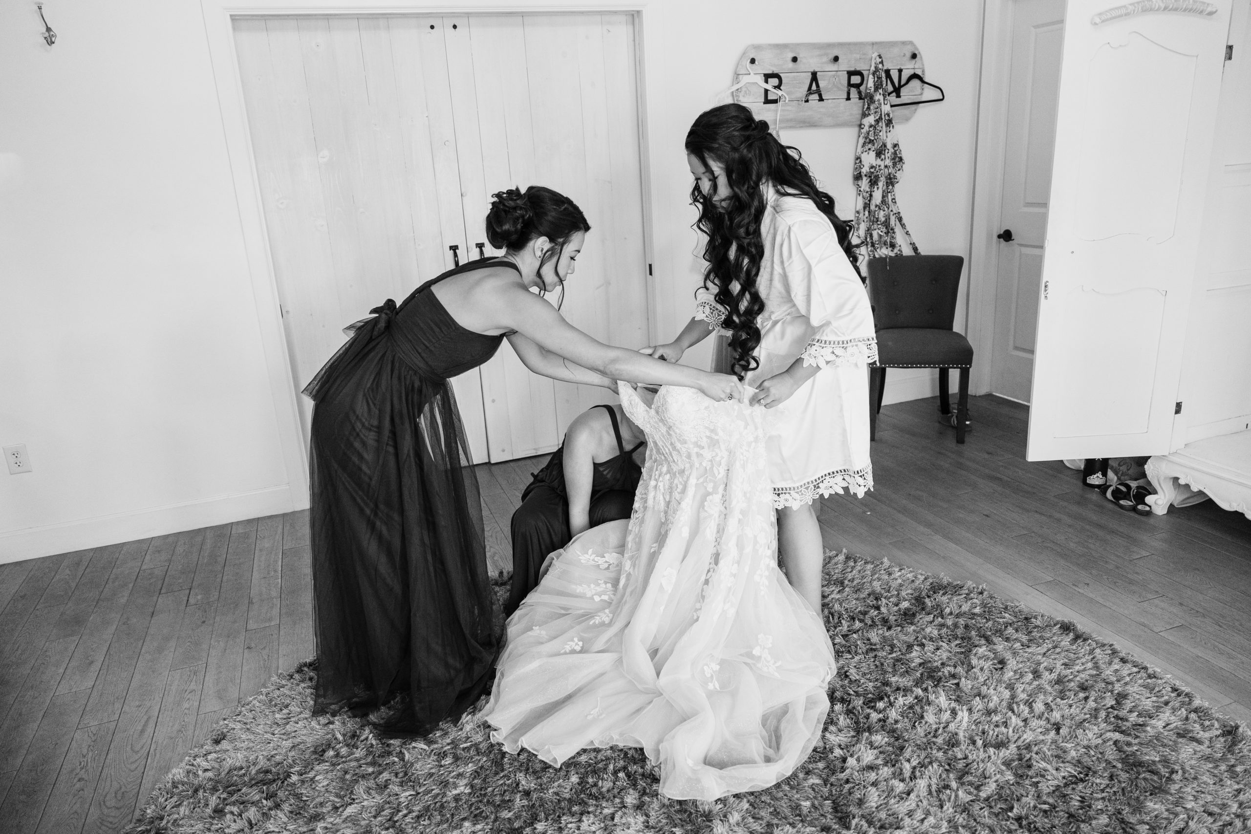 Bride putting on wedding dress